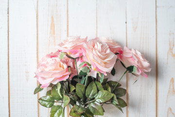 Top view of wedding flowers on white wood background