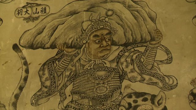 Extreme close-up low-angle still shot of one of the 36 celestial guardians on wall mural at Khoo Kongsi, Georgetown, Penang, Malaysia