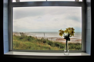 View through a window onto the beach of St Bees. On the west coast of England, near Lake District. North-west Europe.
