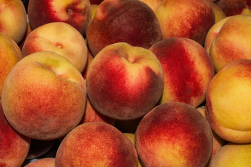 Peach Background. Texture background of sweet red ripe peaches. Ripe peaches close-up.