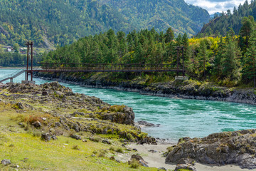 Suspended pedestrian bridge over the Katun river near the village of Elanda
