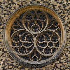 Closeup architectural detail circular ornamented window in medieval church wall