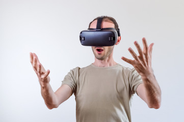 Man exploring modern technology virtual reality with head mounted display on white background