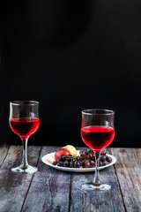 Pink wine. Wine in a glass near fruits and grapes. Traditional Georgian wine according to ancient technology. Copy space Close up and vertical orientation.