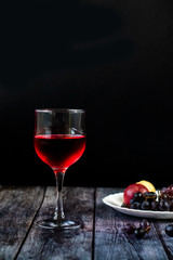 Pink wine. Wine in a glass near fruits and grapes. Traditional Georgian wine according to ancient technology. Copy space Close up and vertical orientation.