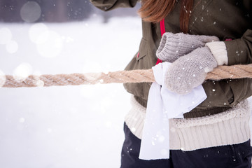 group of young people pulling a rope in tug of war competition