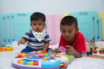 Two little brother baby play toy in room