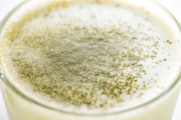 close up of green matcha tea in glass