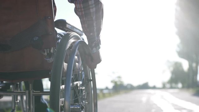 A Man in a Wheelchair Walks on the Waterfront