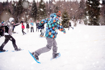 group of young people having a running competition on winter day