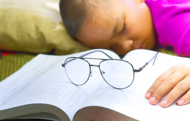 Studying hard in Asia concept.boy sleeping after reading in the room.