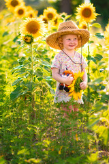 little girl in sunflower field