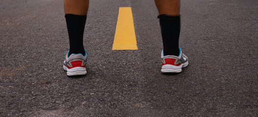 Fototapeta na wymiar Close up of man with shoe on road.Concept of start.