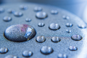 Water droplets on blue metal