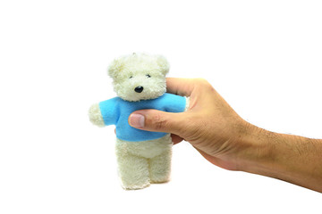 the right  hand of adult holding a white baer doll  on white background isolated