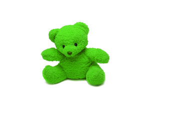 a green bear doll sitting on white background isolated
