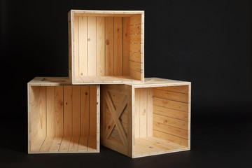 Group of wooden crates on black background