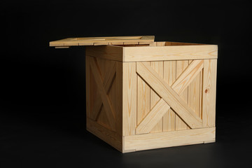 Wooden crate on black background. Space for text