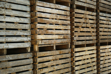 Pile of empty wooden crates outdoors on sunny day