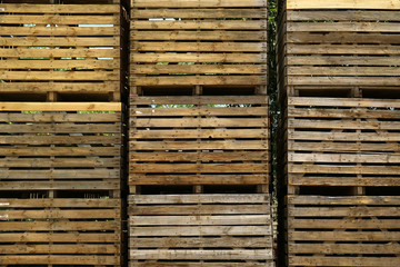 Pile of empty wooden crates outdoors on sunny day