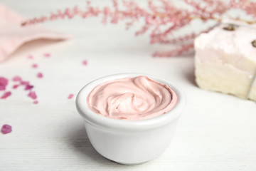 Professional face mask with flowers on white wooden table