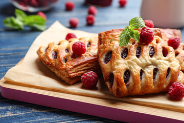 Fresh delicious puff pastry with sweet berries served on blue wooden table