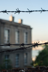 Barbed wire in front of the prison building