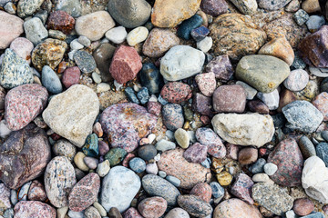 Full frame background of colorful sea stones in close-up on a Baltic coastline