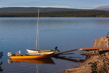 Boats on an anchor in the scenic Lake Saggat near to Arrenjarka in Swedish Lapland, Norrbotten County