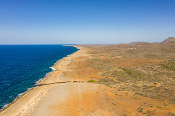 Aerial view of coast of Curaçao in the Caribbean Sea with turquoise water, cliff, beach and beautiful coral reef around Watamula Hole