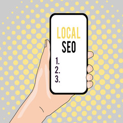 Conceptual hand writing showing Local Seo. Concept meaning helps businesses promote products and services to local customers Closeup of Smartphone Device Held in Hand and Text Space