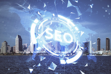 SEO hologram on city view with skyscrapers background double exposure. Search optimization concept.