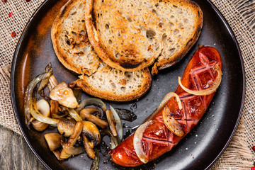 Grilled sausage, toasts and mushrooms