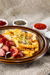 Grilled sausages, French fries and vegetables