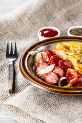 Grilled sausages, French fries and vegetables
