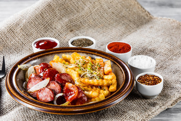 Grilled sausages, French fries and vegetables