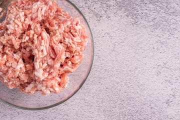 Fresh, minced meat in a plate on the table in the kitchen. Cooking minced meat for meatballs.