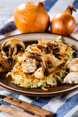 Potato cakes with chopped pork, gravy sauce and champignon