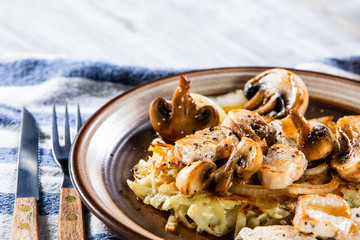 Potato cakes with chopped pork, gravy sauce and champignon