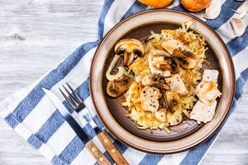 Potato cakes with chopped pork, gravy sauce and champignon