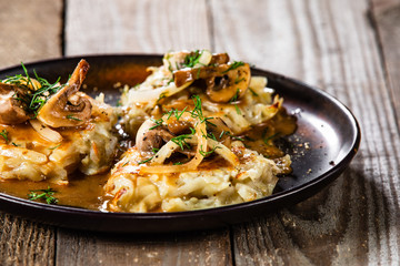 Potato cakes with gravy sauce and champignon