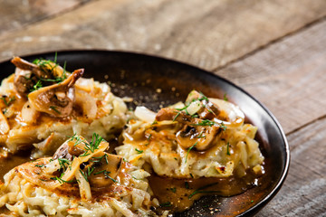 Potato cakes with gravy sauce and champignon