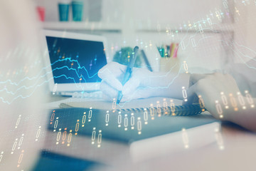 Financial graph displayed on woman's hand taking notes background. Concept of research. Double exposure