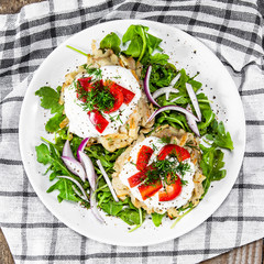 Potato cakes with sour cream and vegetables