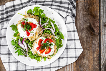 Potato cakes with sour cream and vegetables