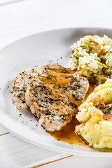 Fried pork chop, mashed potatoes and cabbageon