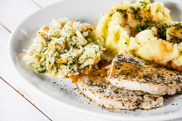 Fried pork chop, mashed potatoes and cabbageon