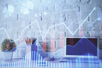 Financial graph colorful drawing and table with computer on background. Double exposure. Concept of international markets.