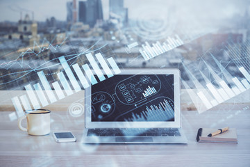 Financial chart drawing and table with computer on background. Double exposure. Concept of...