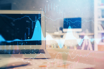 Stock market graph and table with computer background. Double exposure. Concept of financial analysis.